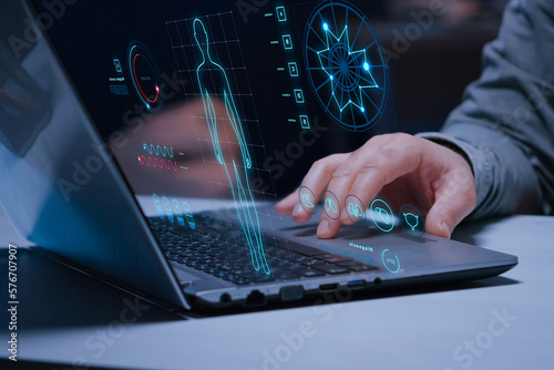 Doctor using future technology on a laptop for treatment. Medical technology and futuristic concept. Health Check with digital system support for patient with medical icon at hospital medical network.