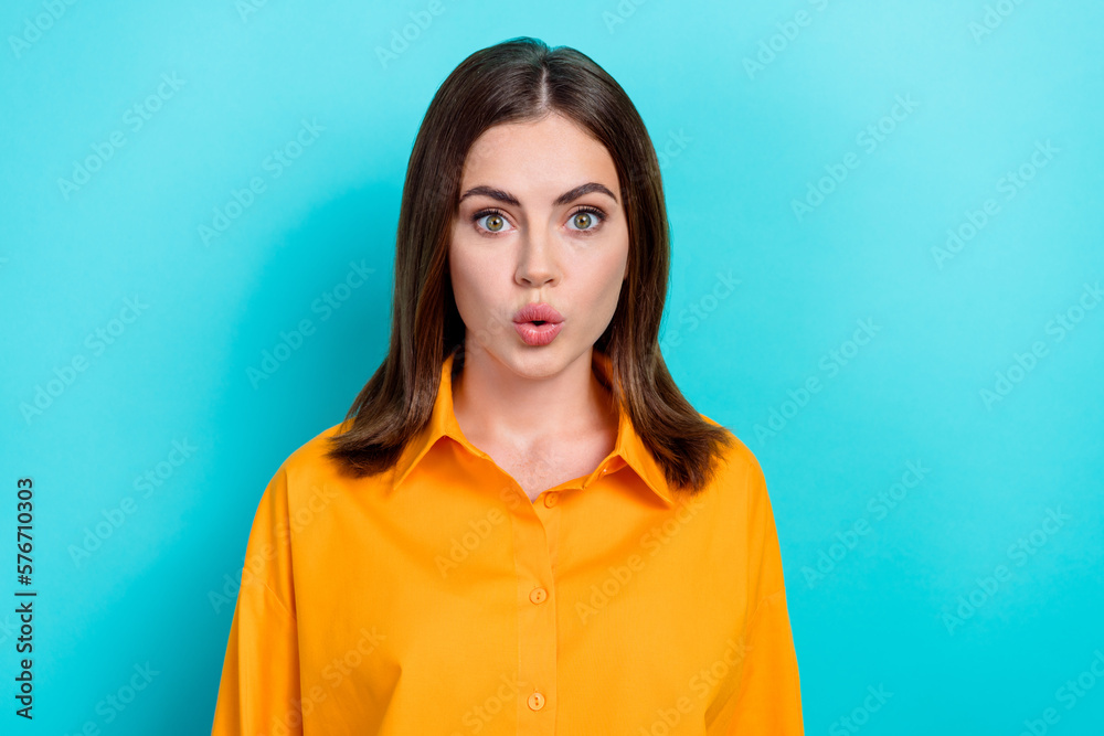 Portrait of impressed lovely speechless girl with bob hairstyle dressed yellow shirt astonished staring isolated on blue color background Portrait of impressed lovely speechless girl with bob hairstyle dressed yellow shirt astonished staring isolated on blue color background