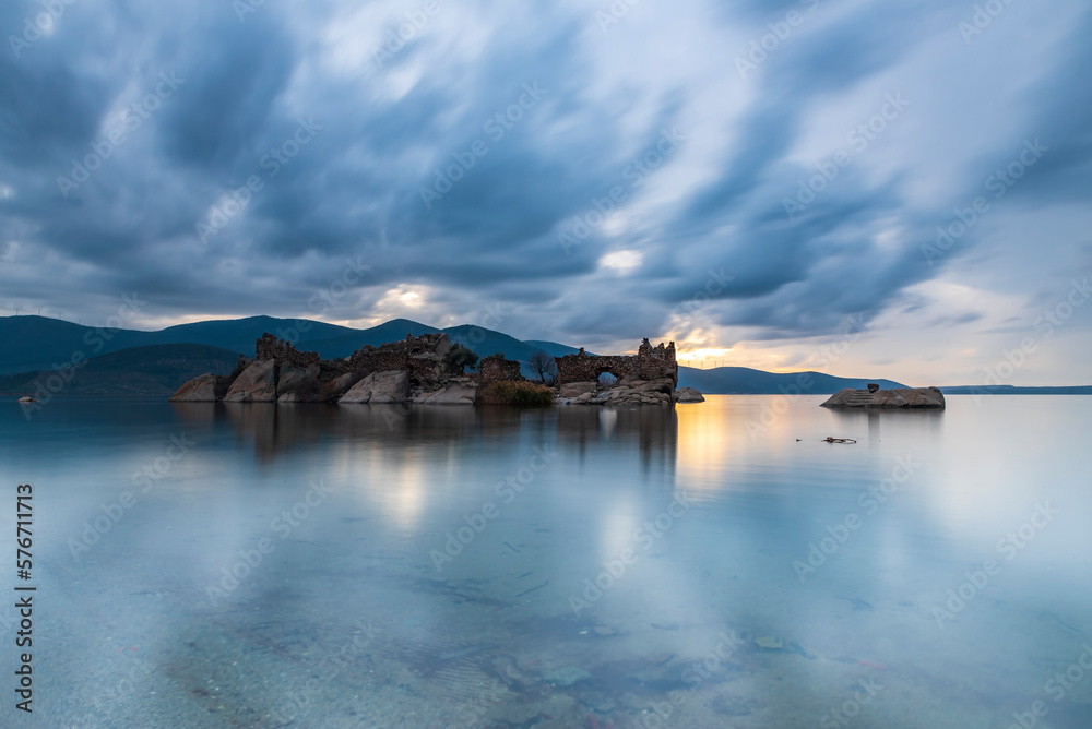 Different views of Bafa Lake in Aegean province of Turkey, boats pier island with monastery and rock forms on a colorful sunset and reflections Different views of Bafa Lake in Aegean province of Turkey, boats pier island with monastery and rock forms on a colorful sunset and reflections