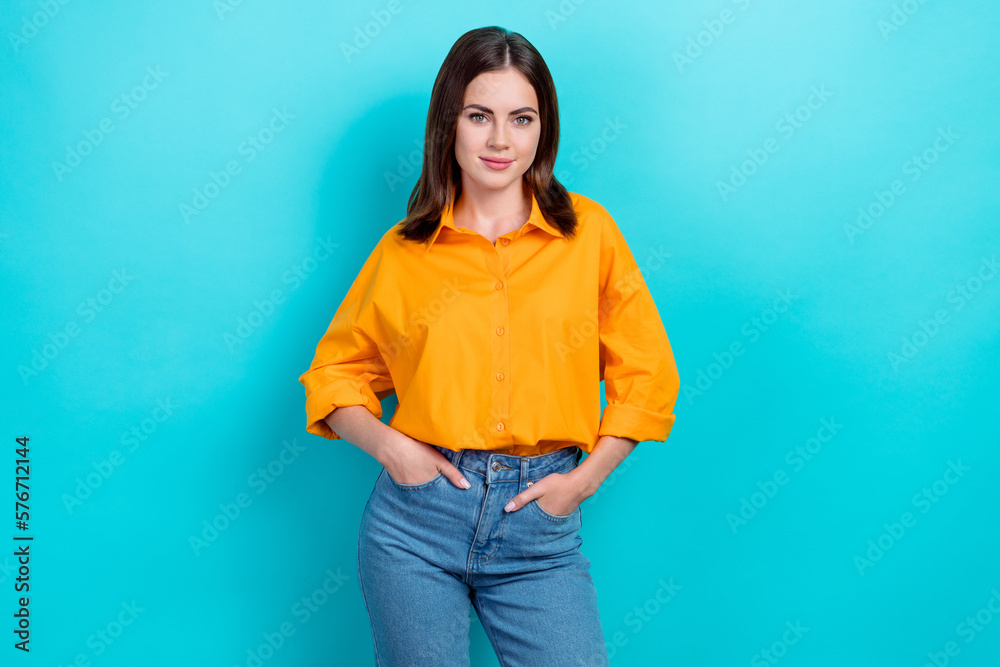 Portrait of gorgeous pretty cute girl with bob hairstyle dressed yellow shirt hold arms in pockets isolated on blue color background Portrait of gorgeous pretty cute girl with bob hairstyle dressed yellow shirt hold arms in pockets isolated on blue color background