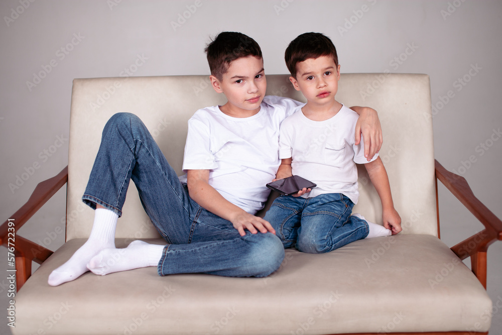 Two boys sitting together in studio