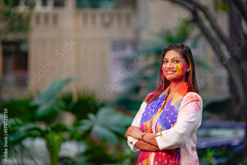 indian young girl showing colourful palm and celebrating holi