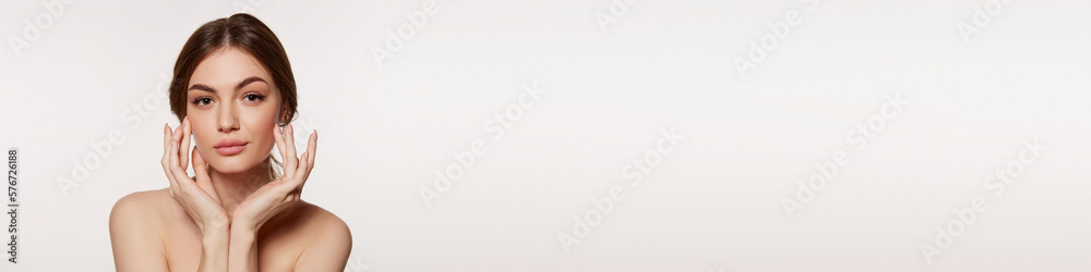 Tender, young, beautiful girl with perfect well-kept skin over grey studio background. Taking care after skin. Concept of cosmetology, plastic surgery, natural beauty. Banner, flyer. Tender, young, beautiful girl with perfect well-kept skin over grey studio background. Taking care after skin. Concept of cosmetology, plastic surgery, natural beauty. Banner, flyer.