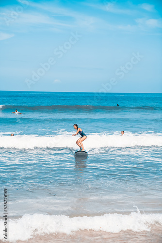 Surfing. A surfer on the waves in the ocean off the coast of Asia on the island of Bali in Indonesia. Sports and extreme. Beauty and health. Fashion and beach style. © algrigo