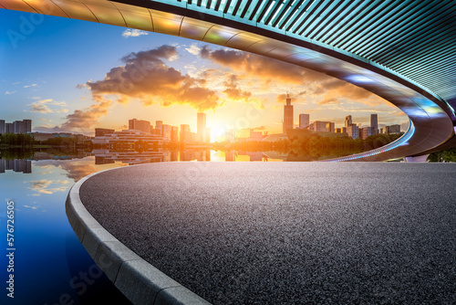 Asphalt road and bridge with modern city skyline at sunset in Ningbo, Zhejiang Province, China. © ABCDstock