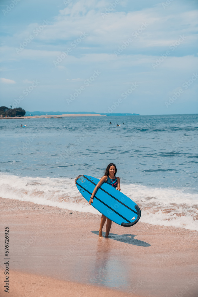 Surfing. A surfer on the waves in the ocean off the coast of Asia on the island of Bali in Indonesia. Sports and extreme. Beauty and health. Fashion and beach style. Surfing. A surfer on the waves in the ocean off the coast of Asia on the island of Bali in Indonesia. Sports and extreme. Beauty and health. Fashion and beach style.