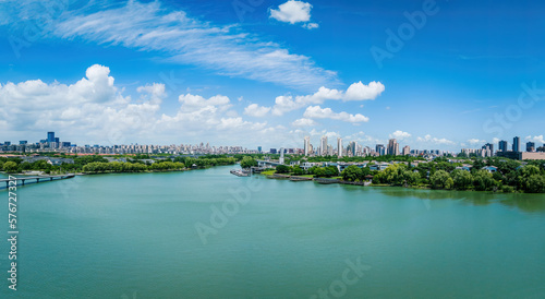 Aerial view of city skyline and modern buildings with lake scenery in Suzhou, China.