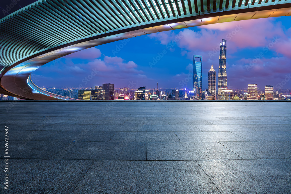 Empty square floor and bridge with city skyline at night in Shanghai, China. - obrazy, fototapety, plakaty 