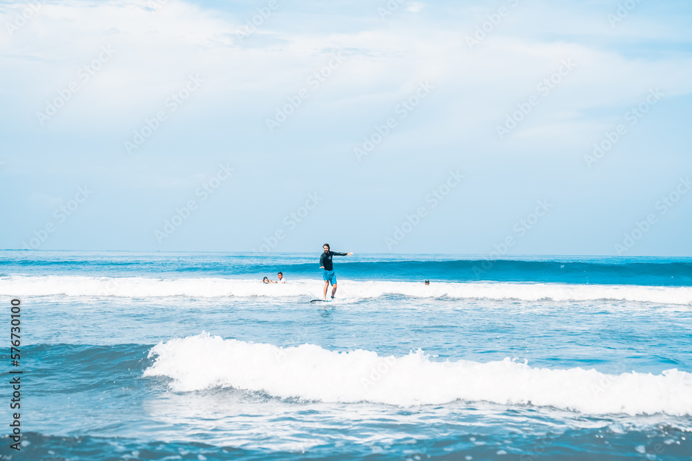 Surfing. A surfer on the waves in the ocean off the coast of Asia on the island of Bali in Indonesia. Sports and extreme. Beauty and health. Fashion and beach style.