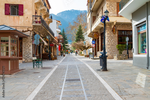 Stone paved street with various of shops and greek taverns in Kalavryta, Peloponnese, Greece