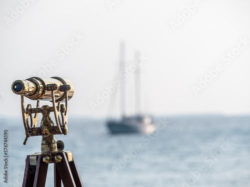 Holiday island in the Maldives, with a telescope aimed at a sailing boat, Maldives, Indian Ocean, Asia photo