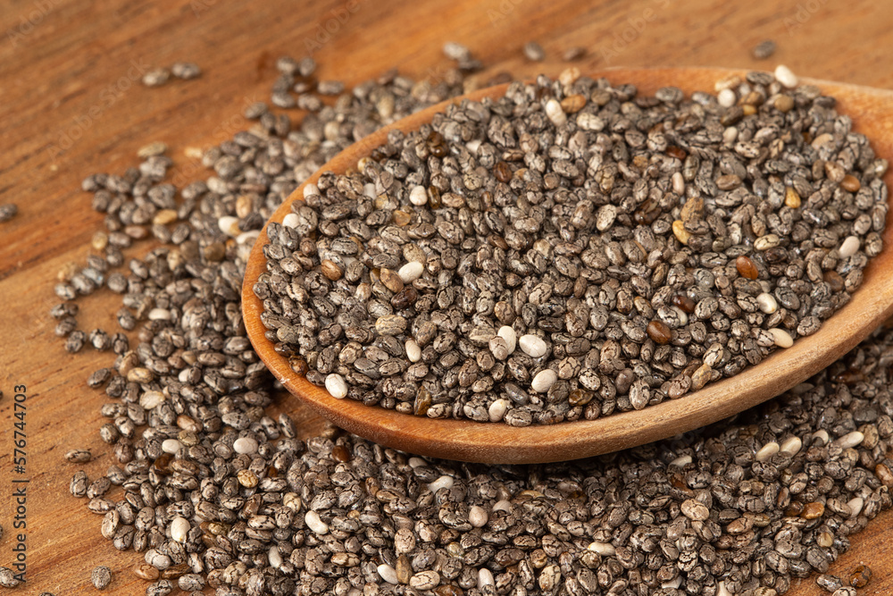 Chia seeds on wooden spoon. Selective focus. Chia seeds on wooden spoon. Selective focus.