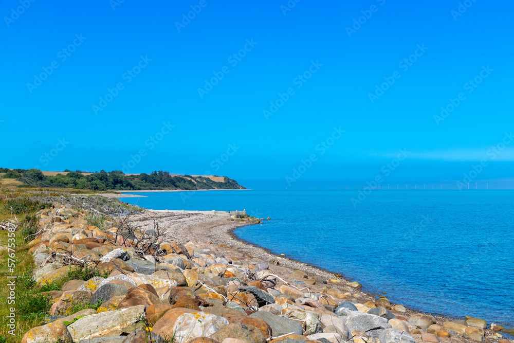 Rocky beach by the sea in Denmark with blue sky Rocky beach by the sea in Denmark with blue sky