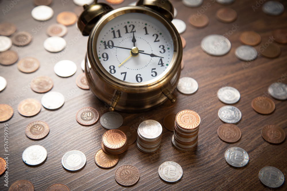 Alarm clock and coins. Business