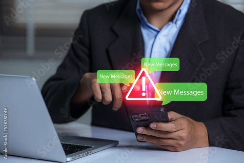 Businessman using smartphone with new message electronic email hacking and spam warning symbol. cyber attack network, virus, spyware, Cyber security and cybercrime.