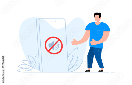 A man stands near the smartphone, on the screen no sound sign. Forbidden sign with loudspeaker