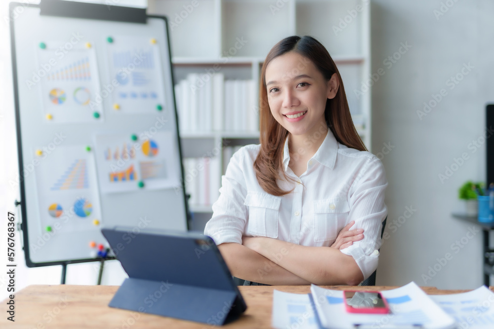 Beautiful asian businesswoman sitting crossed arms smiling looking at camera in office. Beautiful asian businesswoman sitting crossed arms smiling looking at camera in office.