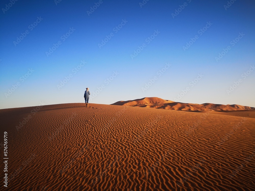 Tuareg man walking in  Sahara desert