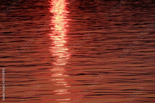 Blurred river view with golden light and sunlight reflection on water surface for background backdrop 
