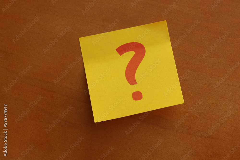 Question mark on yellow sticky paper