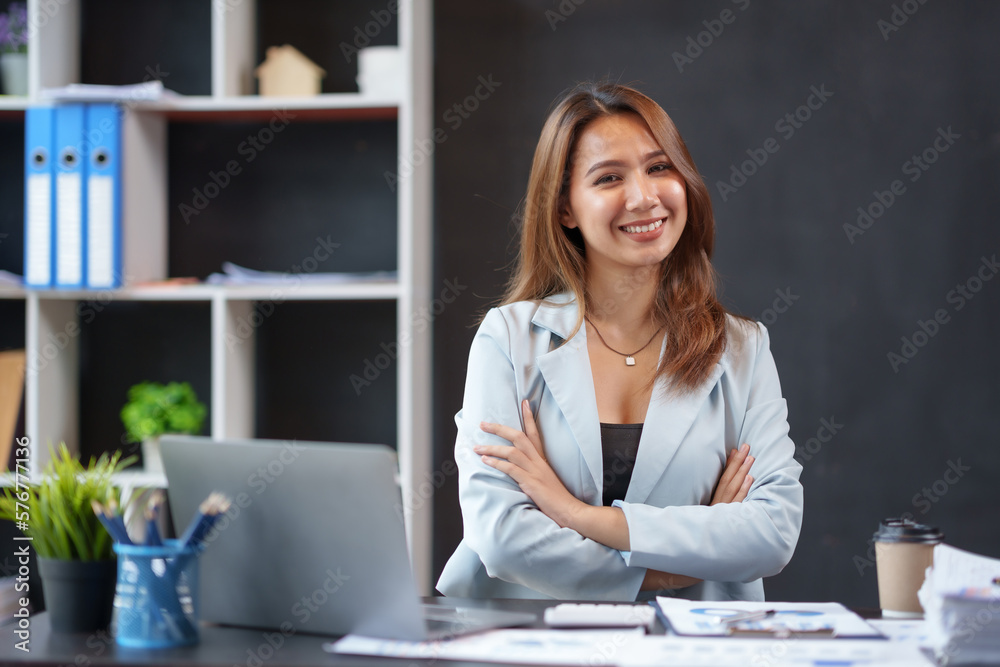 Beautiful asian businesswoman sitting crossed arms smiling looking at camera in office. Beautiful asian businesswoman sitting crossed arms smiling looking at camera in office.