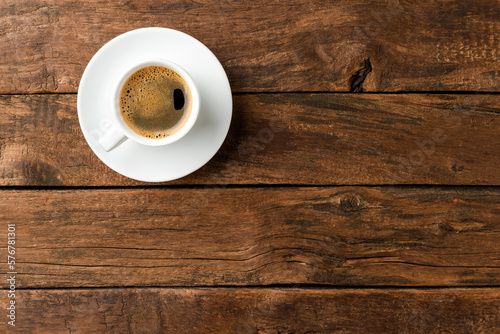 Coffee cup on vintage wooden table with copyspace. Top view
