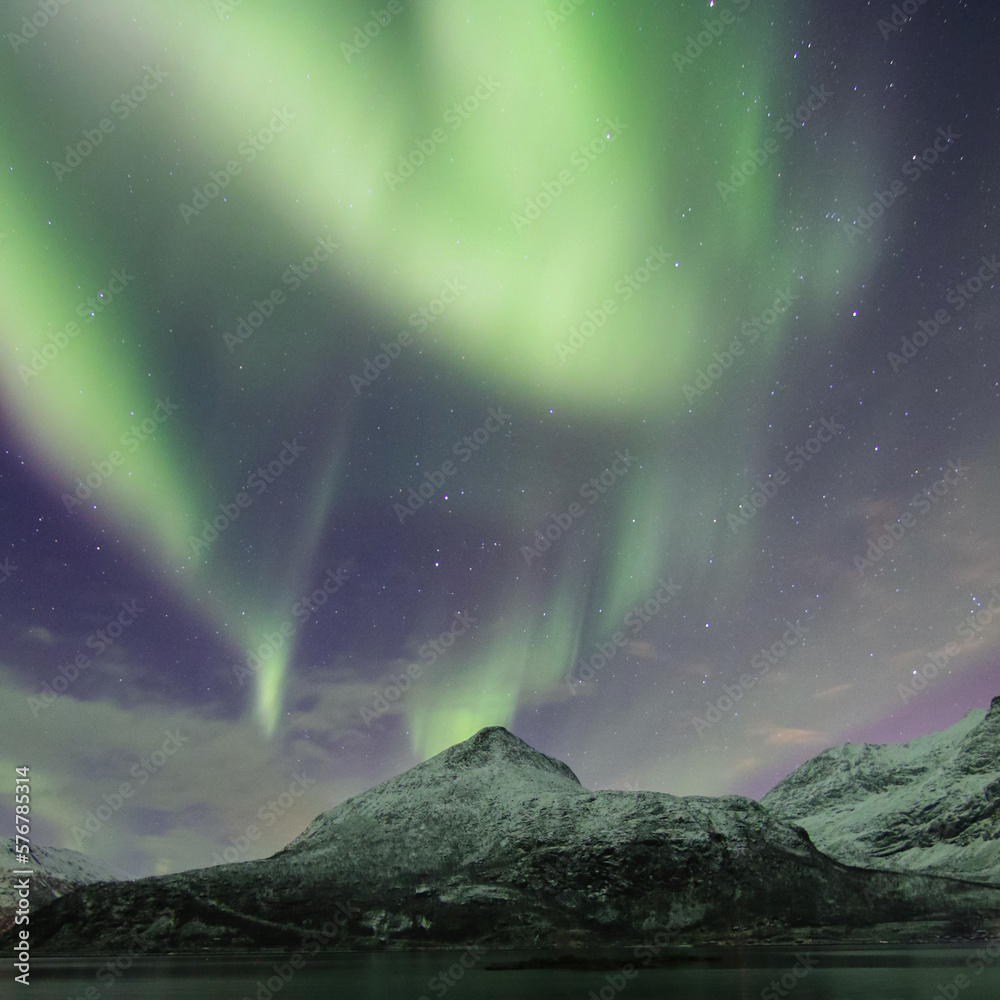 aurora borealis over the mountains. Tromso northern lights