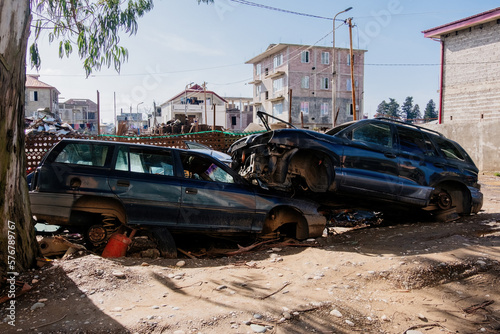 Damaged cars waiting in a wreckyard to be recycled or used for spare parts photo