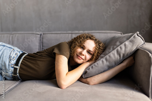 Young pretty woman sleeping on sofa at home