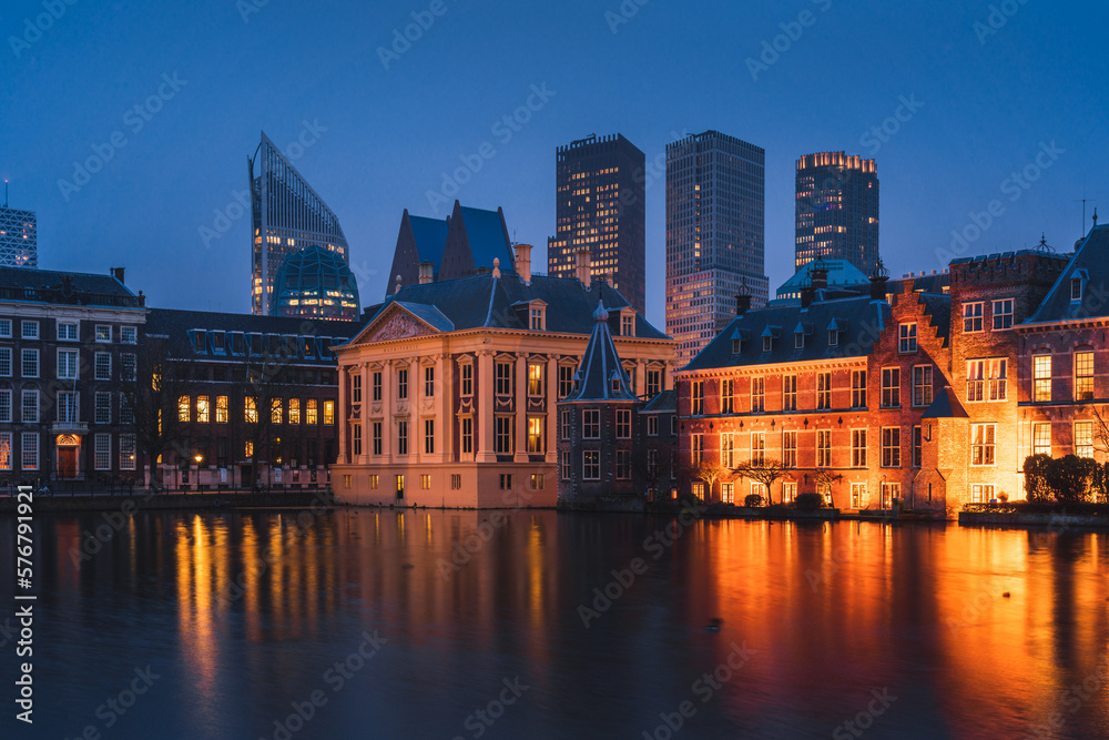 The Hague's Binnenhof with the Hofvijver lake and modern buildings at dusk, Den Haag, Netherlands