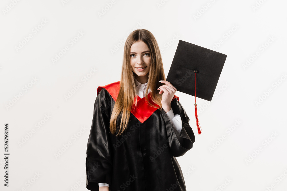 Cheerful bachelor girl in graduation robe and cap on white background. Happy and funny young woman smile. Student achieve master degree in univesity, Cheerful bachelor girl in graduation robe and cap on white background. Happy and funny young woman smile. Student achieve master degree in univesity,