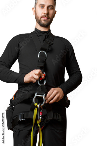 A man in a belay system for work at height. Carabiners, straps, safety ropes. Industrial mountaineering, power generators, towers. High-altitude work. insurance. isolated
