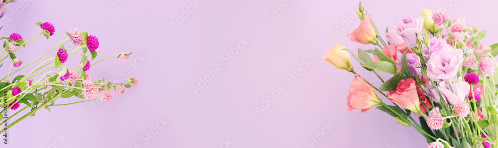 Top view image of pink and purple flowers composition over pastel background Top view image of pink and purple flowers composition over pastel background
