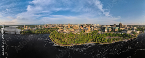 Aerial bird's eye view drone panoramic wide angle shot of Ottawa downtown historic center with Parliament hill and Alexandra Bridge over Ottawa river. Shot on summer sunny day.