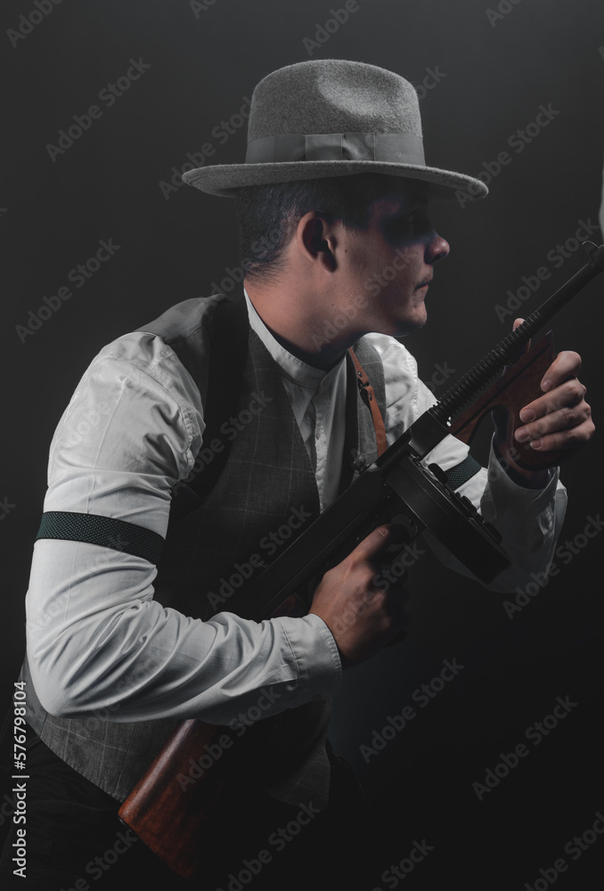 American gangster from Chicago. Early 20th century. Hat and formal suit of shirt and vest. Armed with a pistol and a Thompson submachine gun. A dangerous man who solves problems by force. American gangster from Chicago. Early 20th century. Hat and formal suit of shirt and vest. Armed with a pistol and a Thompson submachine gun. A dangerous man who solves problems by force.