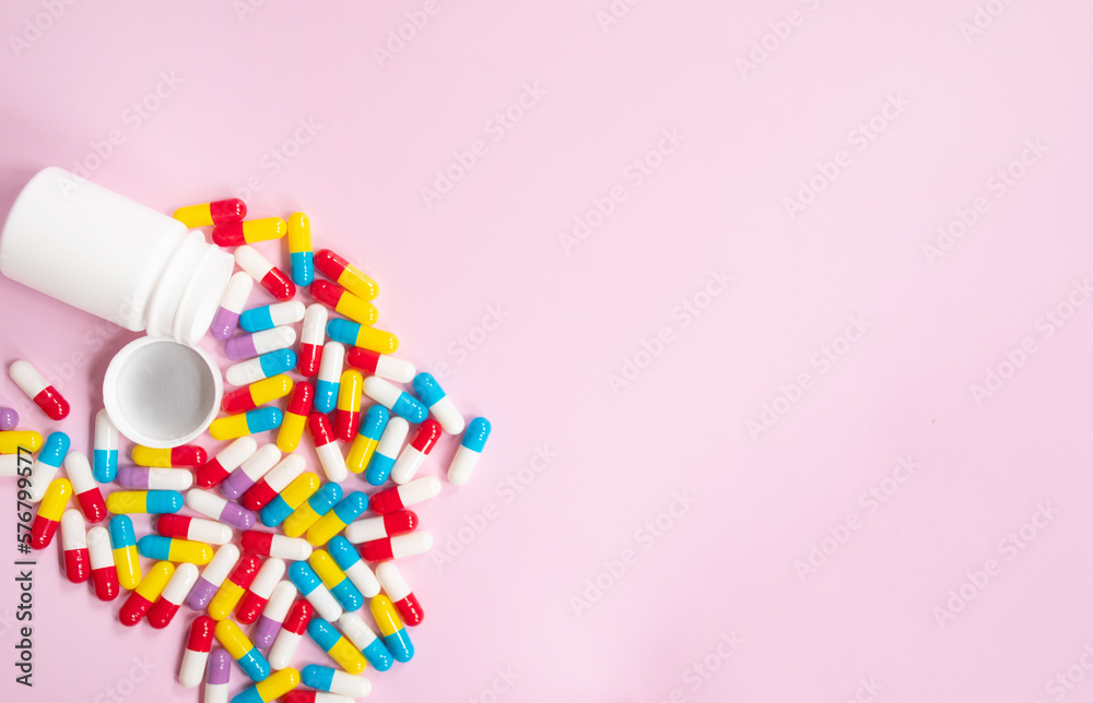 Pills isolated on pink background. The concept of medicine, health insurance or pharmacy. Pills isolated on pink background. The concept of medicine, health insurance or pharmacy.