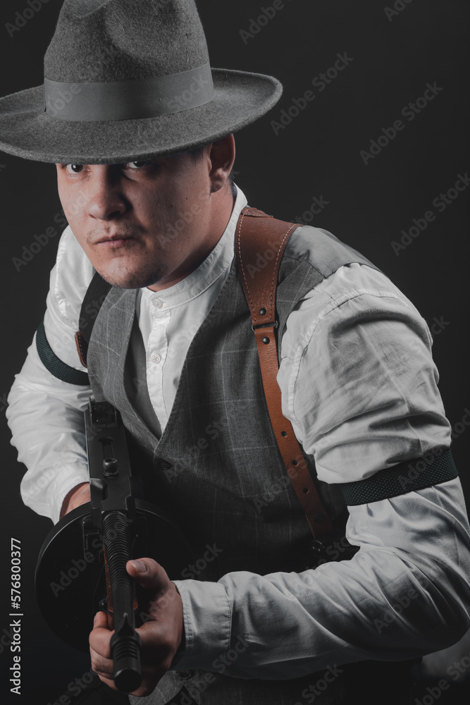 American gangster from Chicago. Early 20th century. Hat and formal suit of shirt and vest. Armed with a pistol and a Thompson submachine gun. A dangerous man who solves problems by force. American gangster from Chicago. Early 20th century. Hat and formal suit of shirt and vest. Armed with a pistol and a Thompson submachine gun. A dangerous man who solves problems by force.