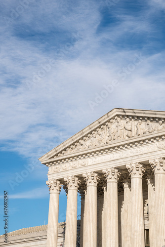 Imposing facade of the United States Suprement Court in Washington, DC with blue sky and copy space.