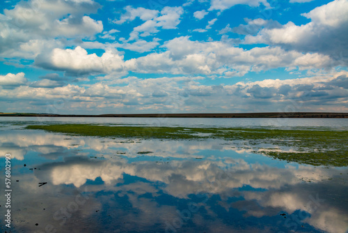 Reflection of white storm clouds in the water of the Tiligul estuary, Ukraine