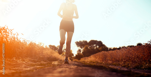 Girl is training, running outdoor in the evening.