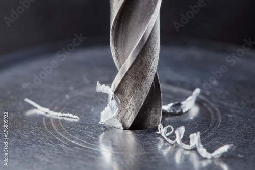 metal drill bit make holes in steel billet on industrial drilling machine. Metal work industry. multi cutting tool and end mill.