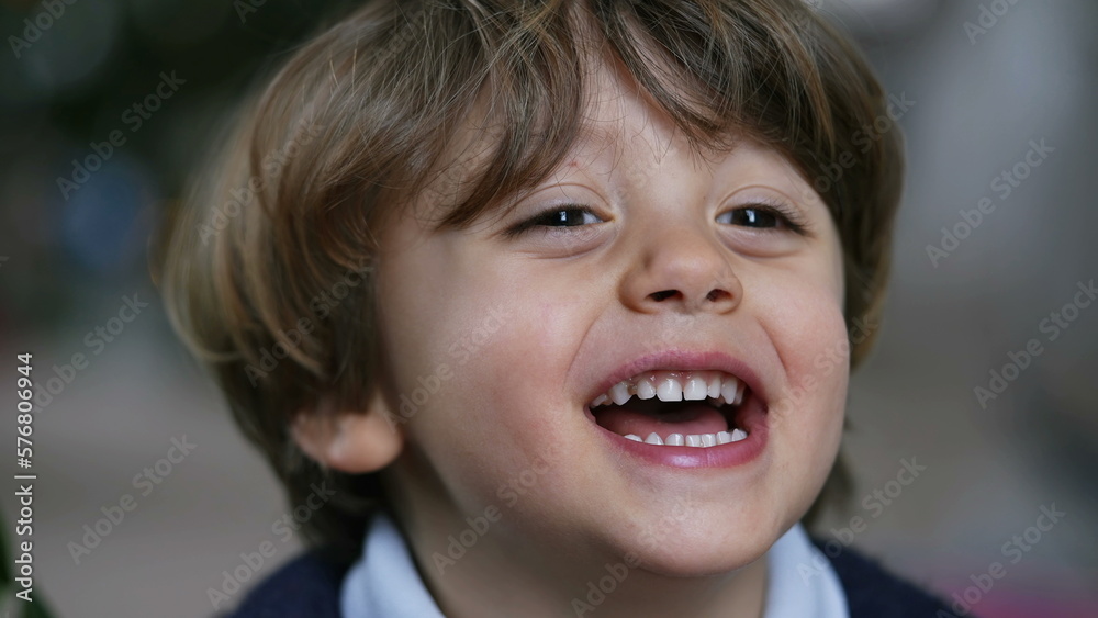 One cute small boy portrait face closeup smiling and laughing One cute small boy portrait face closeup smiling and laughing