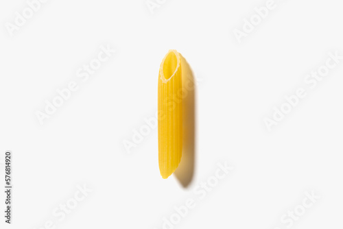 One piece of pasta penne on the white background.
