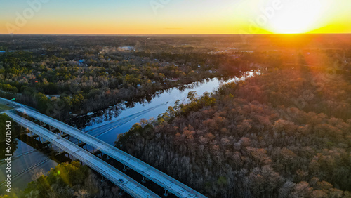 Aerial drone view of a highway bridge crossing the Cape Fear River at sunset in North Carolina