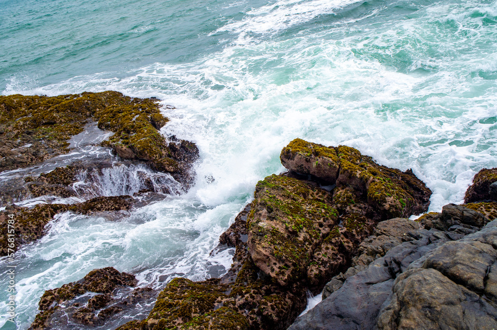 Obraz premium Beautiful tropical landscape. A stone ocean shore with waves and rocks. Beautiful texture background for tourism, design and advertising