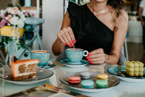 woman details hands drinking coffee eating cakes and macaroons popsi nails inspo aesthetic
