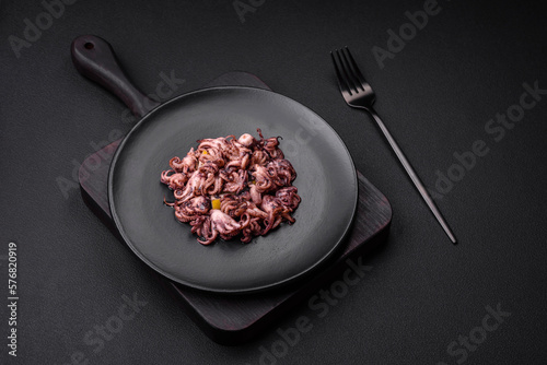 Slika na platnu Delicious marinated octopus babies with lemon, salt and spices