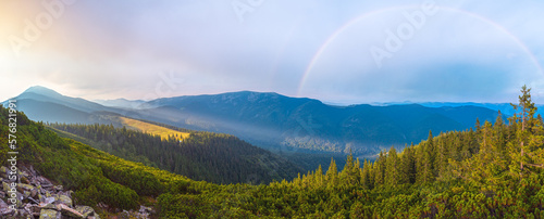 Last sun rays in evening sky with clouds above Syniak mountain. Summer sunset view from Homiak mountain, Gorgany, Carpathian, Ukraine. photo