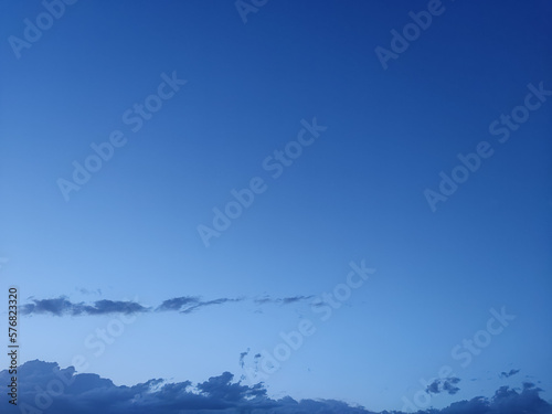 Intense sky of a dark blue color like indigo with clouds of said color