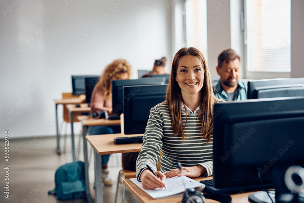 Fototapeta premium Happy woman attending computer class and looking at camera.